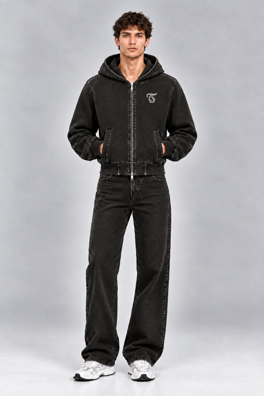 Male model wearing black Capricorn vintage wash full zip hoodie with TS logo, front view; print is illustrative