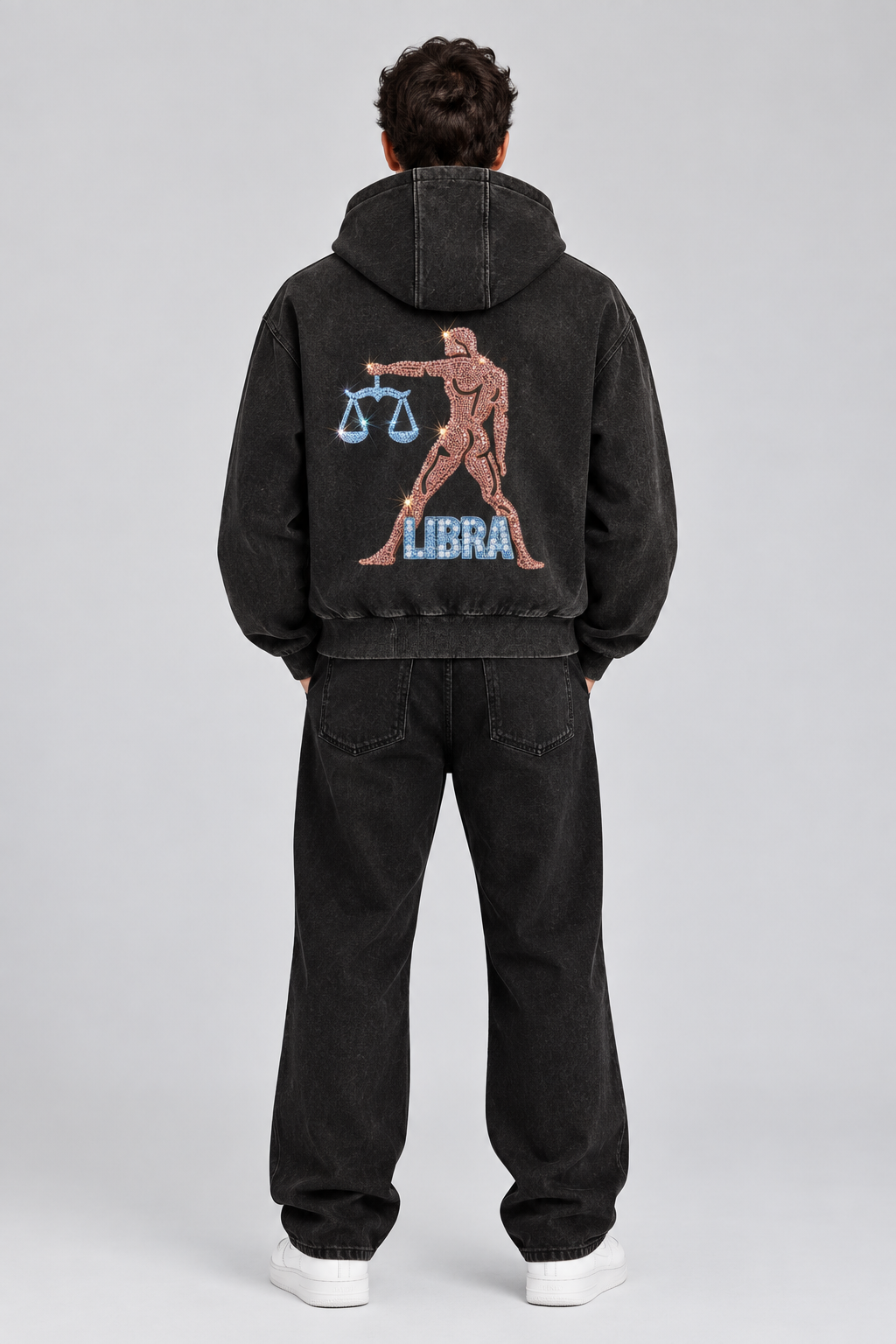 Male model wearing black Libra vintage wash full zip hoodie, back view; print is illustrative