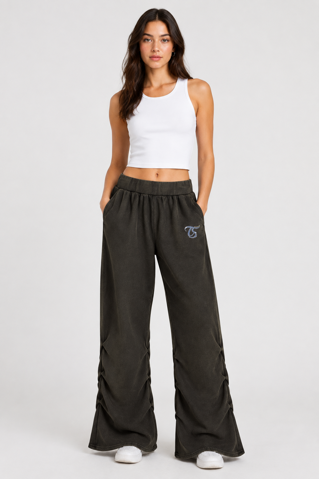 Female model wearing black Scorpio vintage wash ruched sweatpants, front view; artwork is illustrative