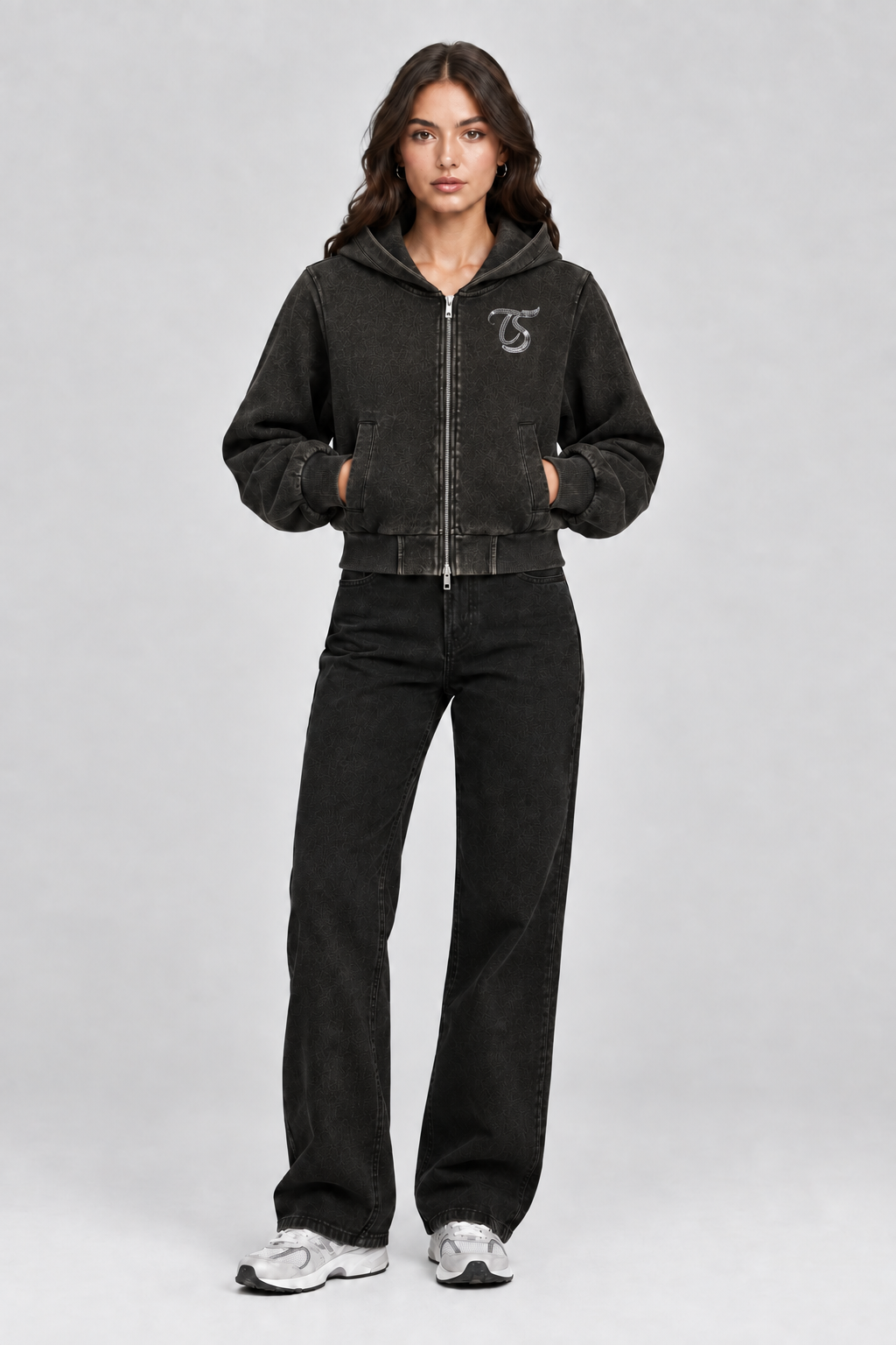Female model wearing black Taurus vintage wash full zip hoodie with TS logo, front view; print is illustrative