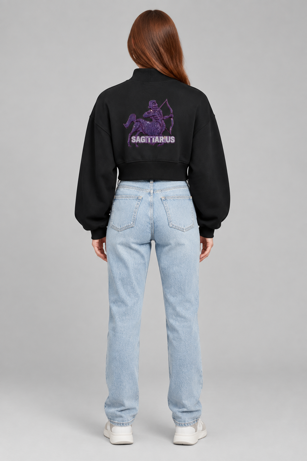 Female model in black Sagittarius women's crop mock neck sweatshirt, back archer design; illustrative print