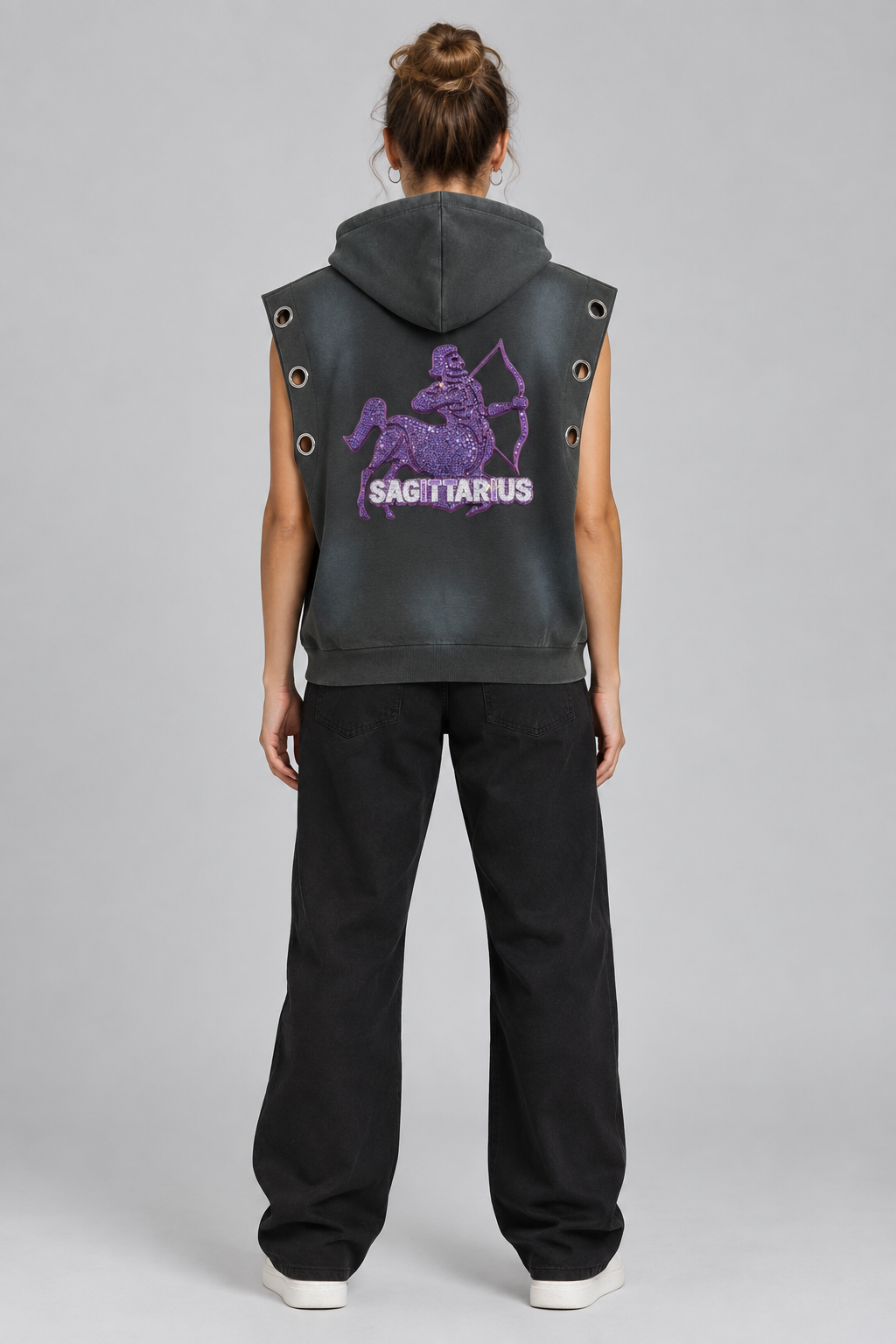 Female model wearing gray Sagittarius sun fade sleeveless hoodie, back archer design; illustrative styling photo