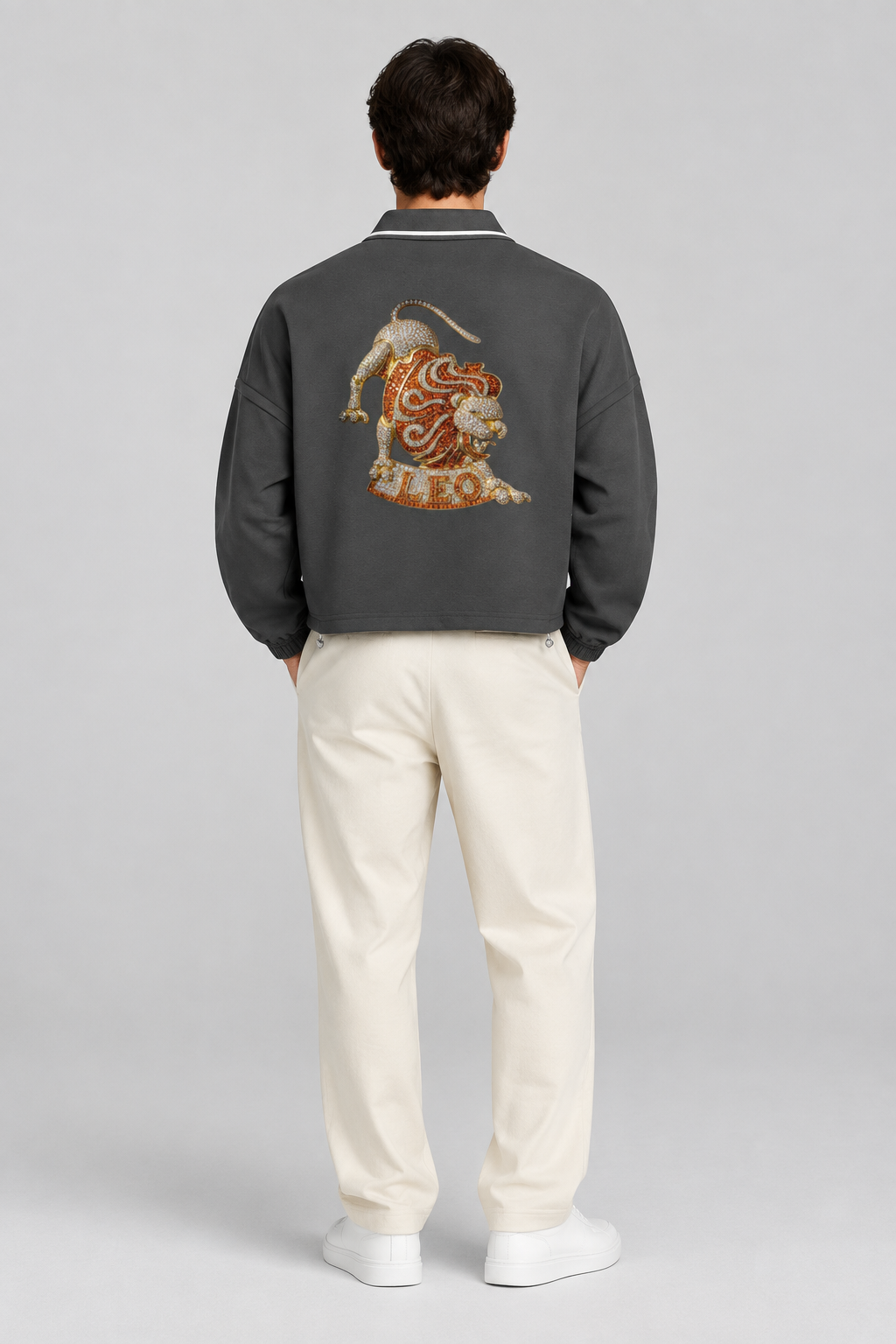 Male model wearing Leo unisex boxy collared detachable sweatshirt with lion artwork, back view; illustrative styling image