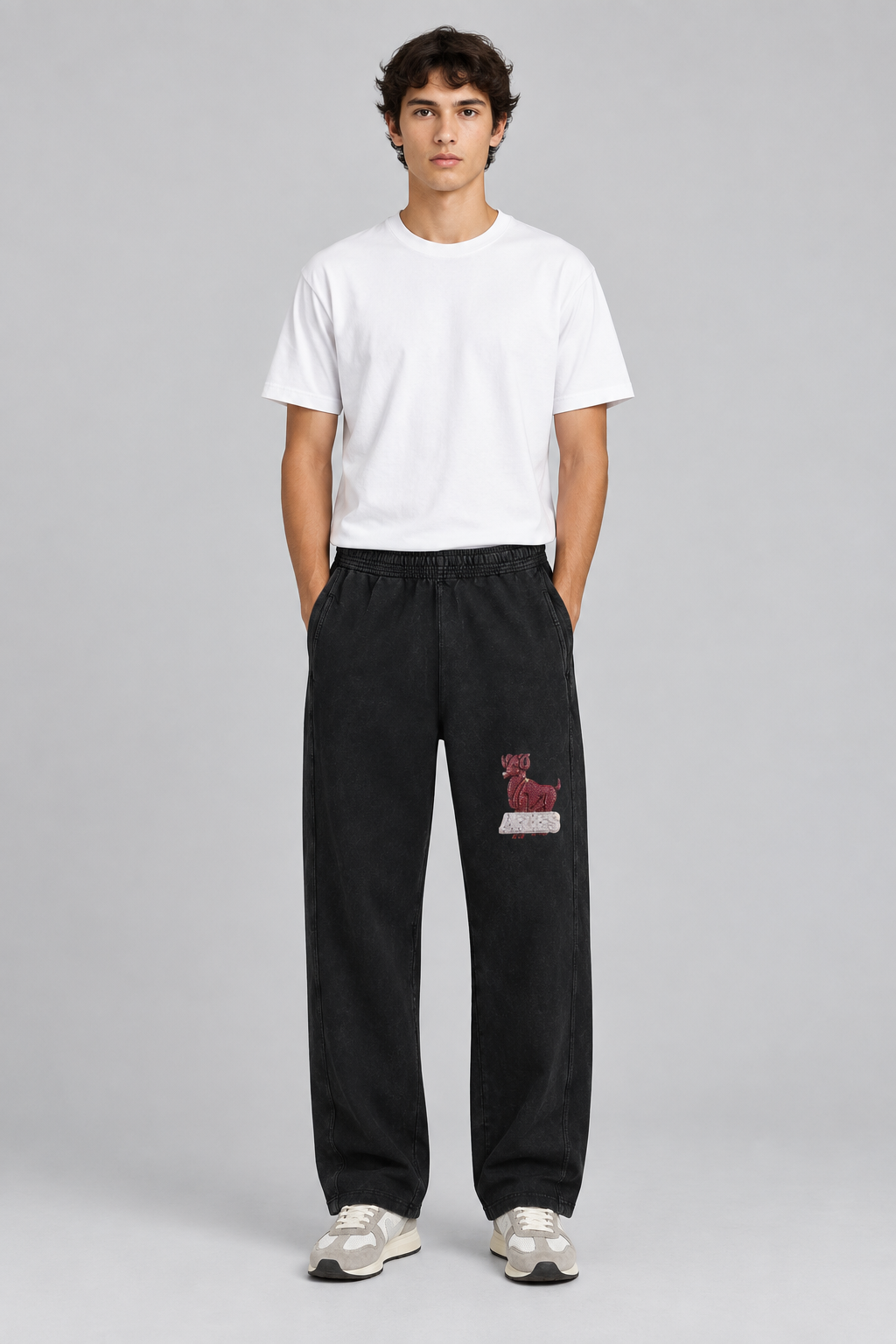 Male model wearing black Aries mineral wash straight sweatpants with Aries front print; print is illustrative