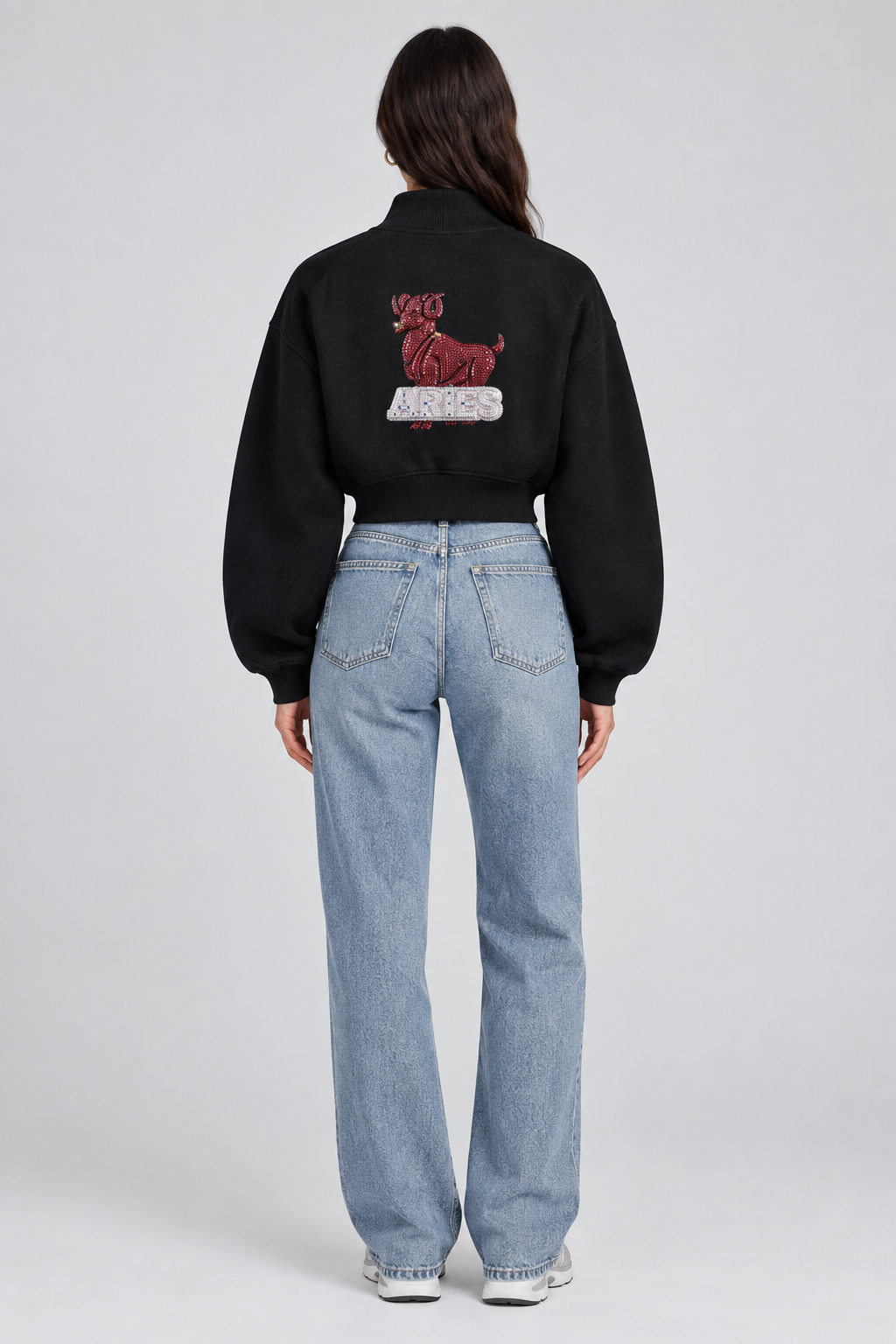 Female model in black Aries women's crop mock neck sweatshirt, back with Aries design; illustrative print