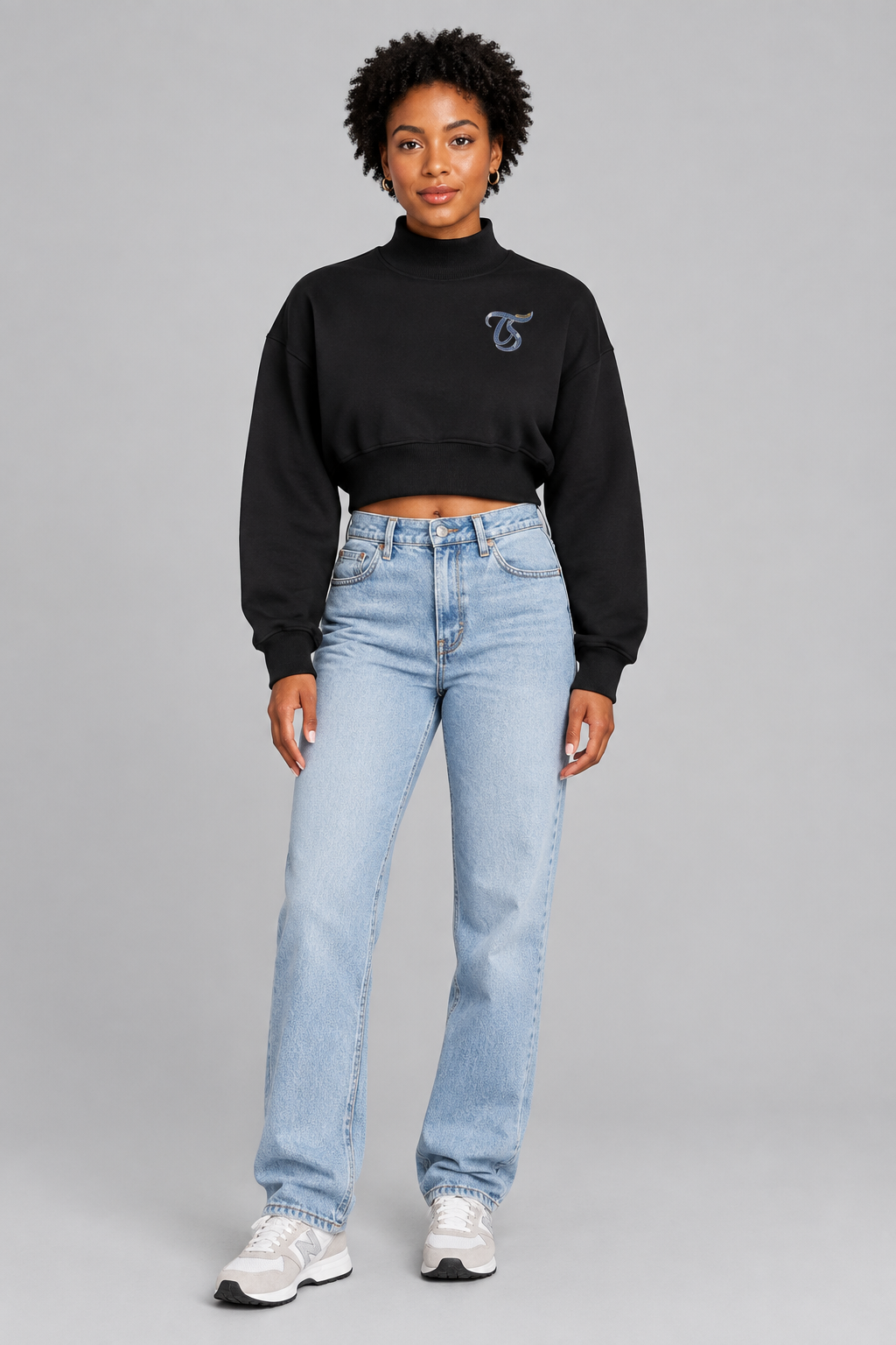 Female model in black Scorpio women's crop mock neck sweatshirt, front TS chest mark; illustrative print
