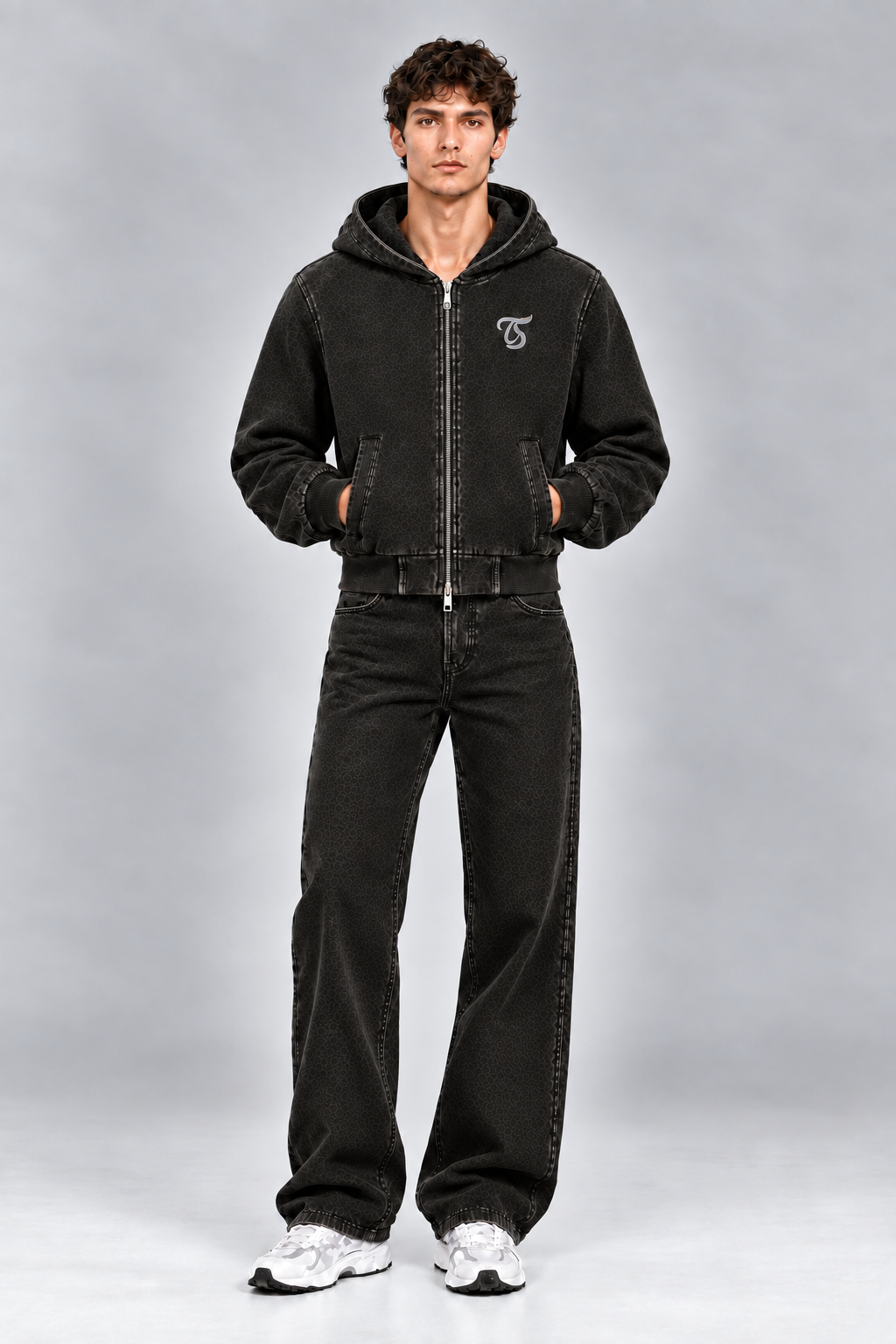 Male model wearing black Aquarius vintage wash full zip hoodie with TS logo, front view; print is illustrative