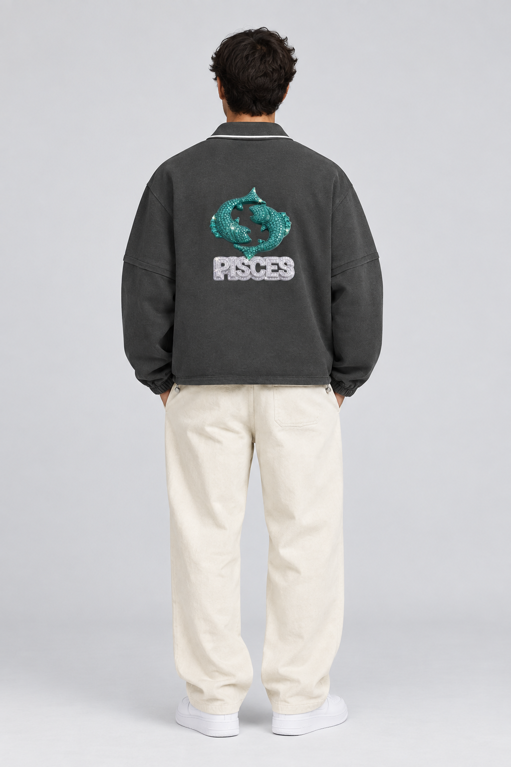 Male model wearing Pisces unisex boxy collared detachable sweatshirt with fish artwork, back view; illustrative styling image