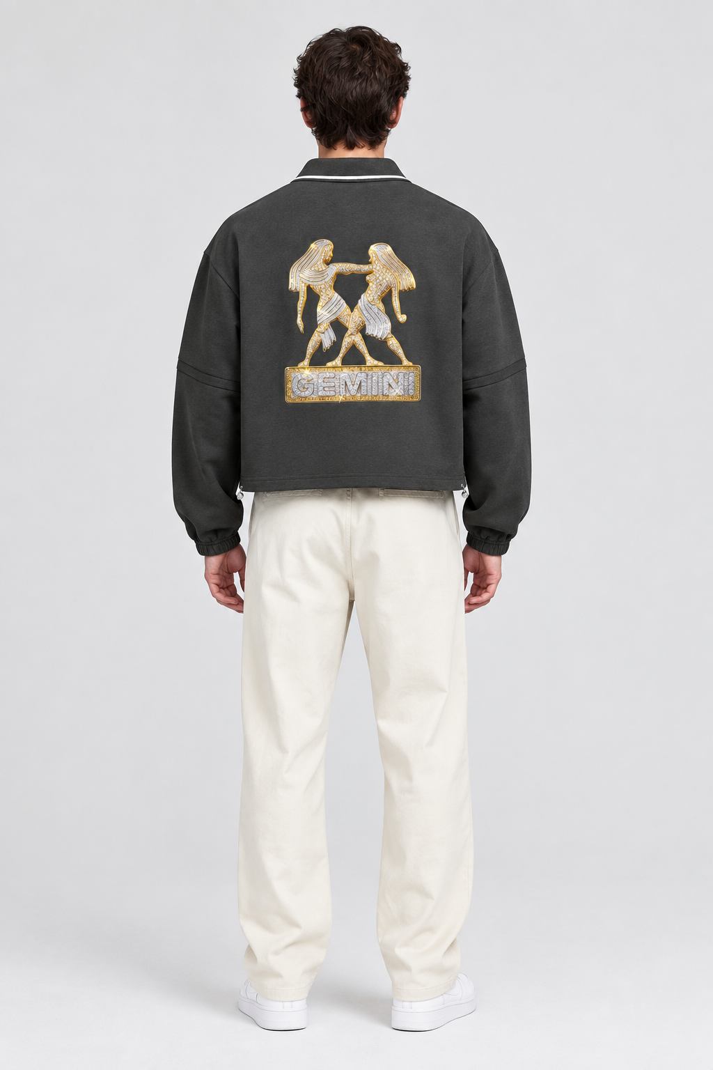 Male model wearing Gemini unisex boxy collared detachable sweatshirt with twin artwork, back view; illustrative styling image