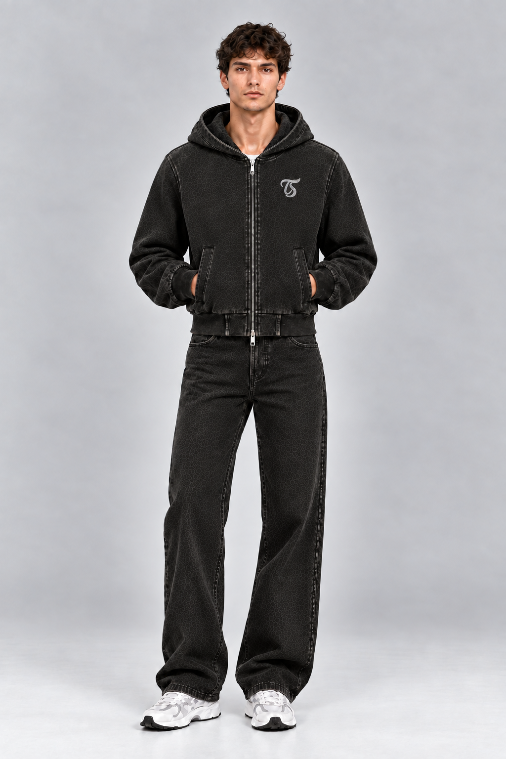 Male model wearing black Sagittarius vintage wash full zip hoodie with TS logo, front view; print is illustrative