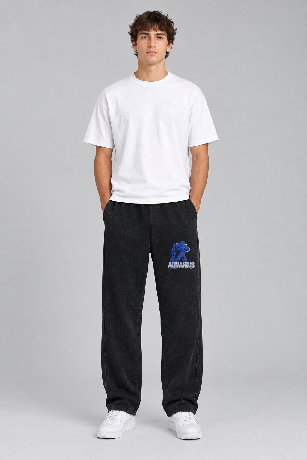 Male model wearing black Aquarius mineral wash straight sweatpants, Aquarius front thigh design; illustrative print