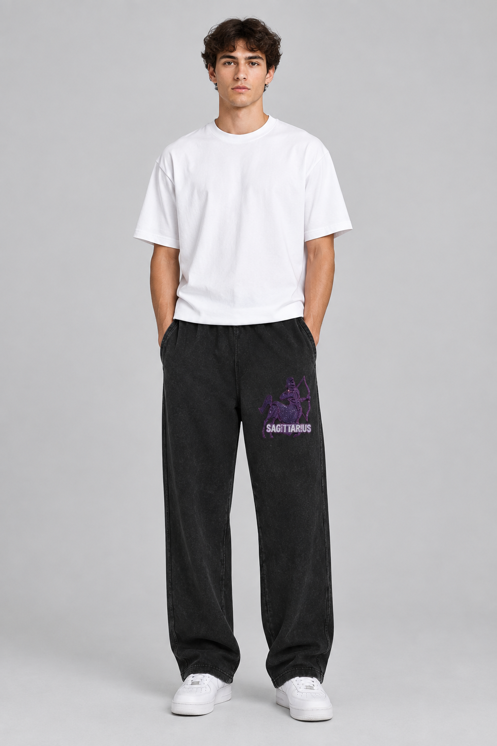 Male model wearing black Sagittarius mineral wash straight sweatpants with Sagittarius front thigh design; illustrative print