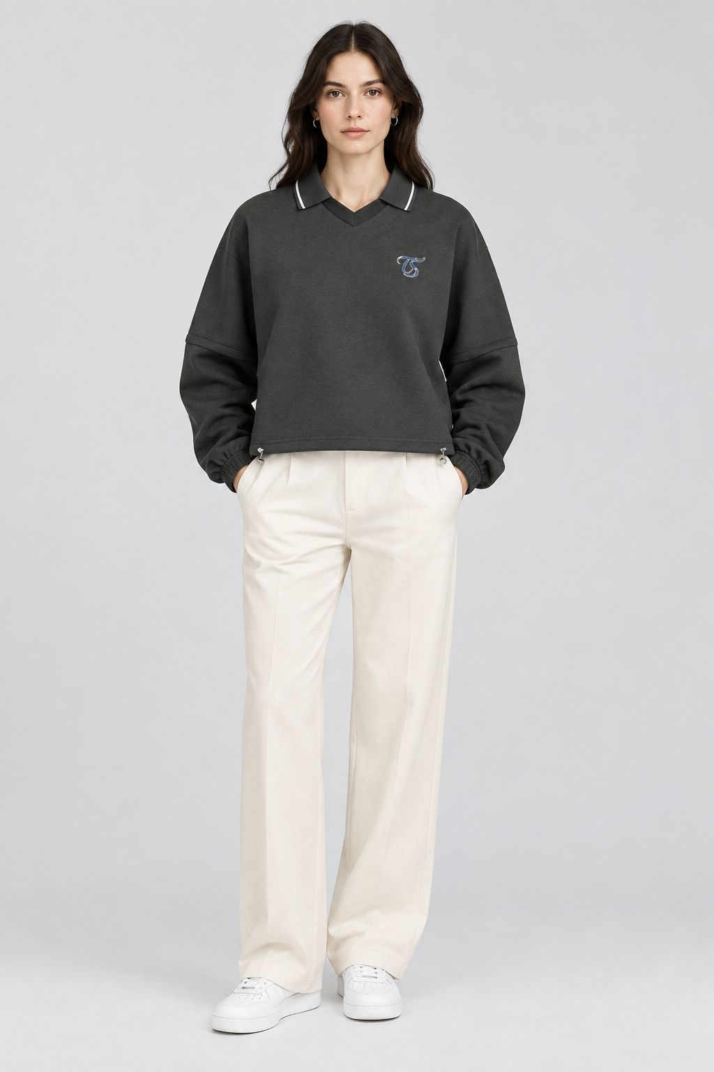 Female model wearing Cancer unisex boxy collared detachable sweatshirt, front view; illustrative styling image