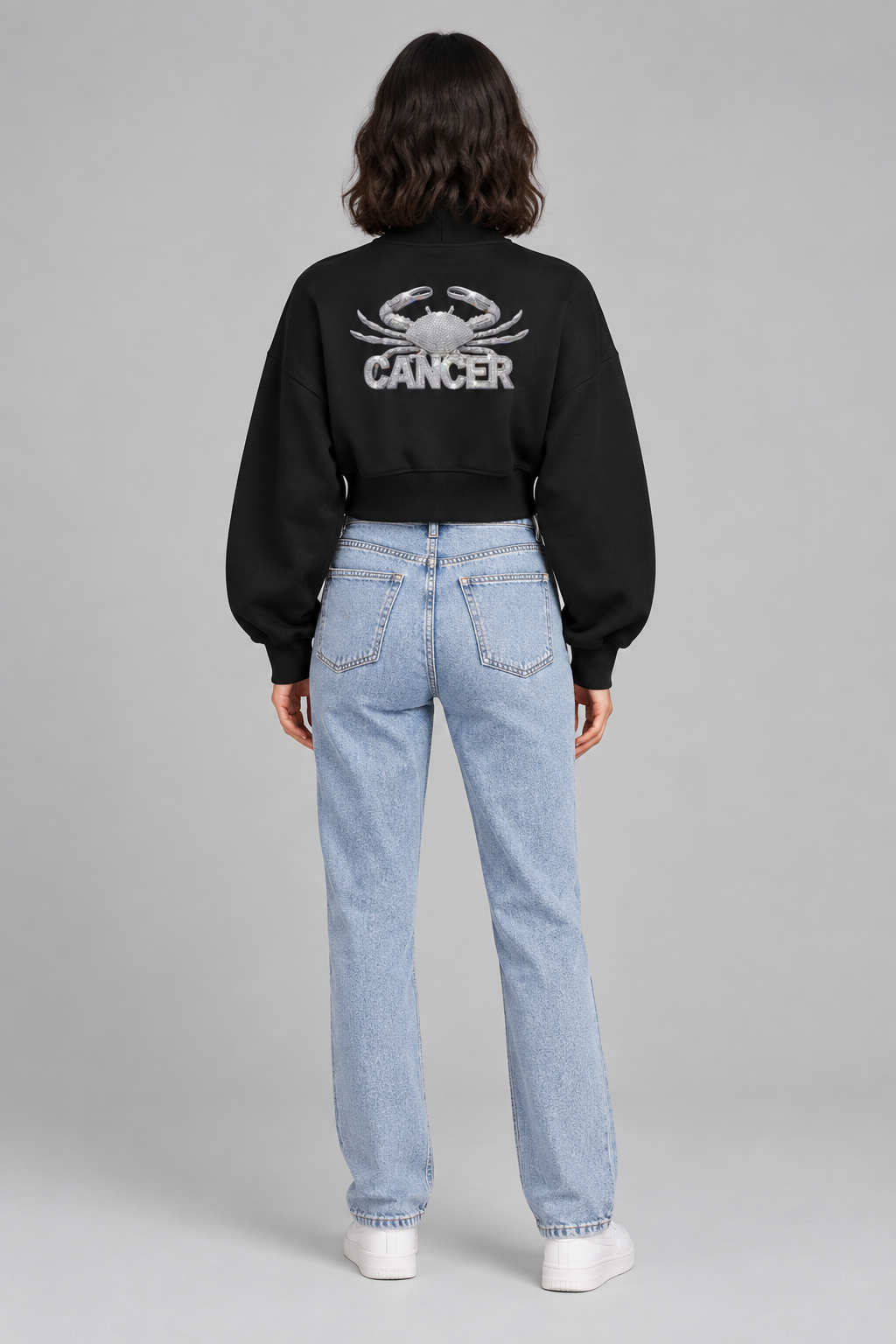 Female model in black Cancer women's crop mock neck sweatshirt, back with Cancer crab design; illustrative print
