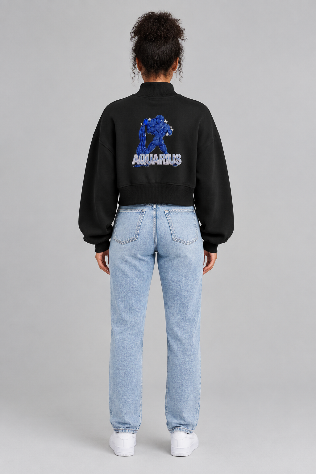 Female model in black Aquarius women's crop mock neck sweatshirt, back blue Aquarius design; illustrative print