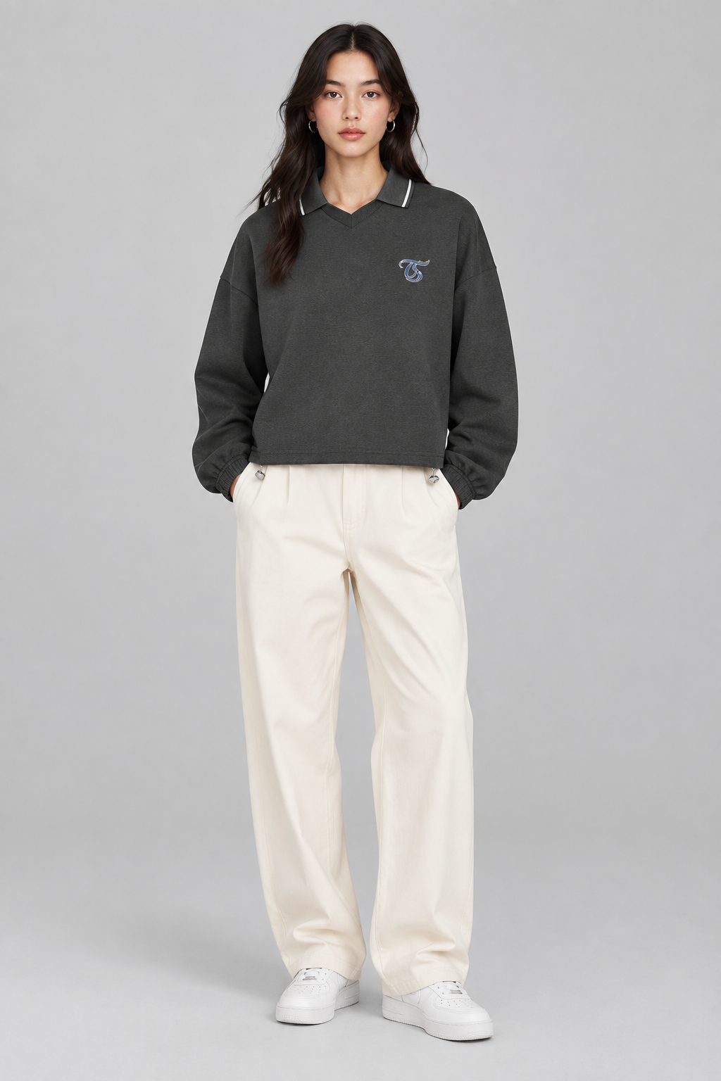 Female model wearing Aquarius unisex boxy collared detachable sweatshirt, front view; illustrative styling image