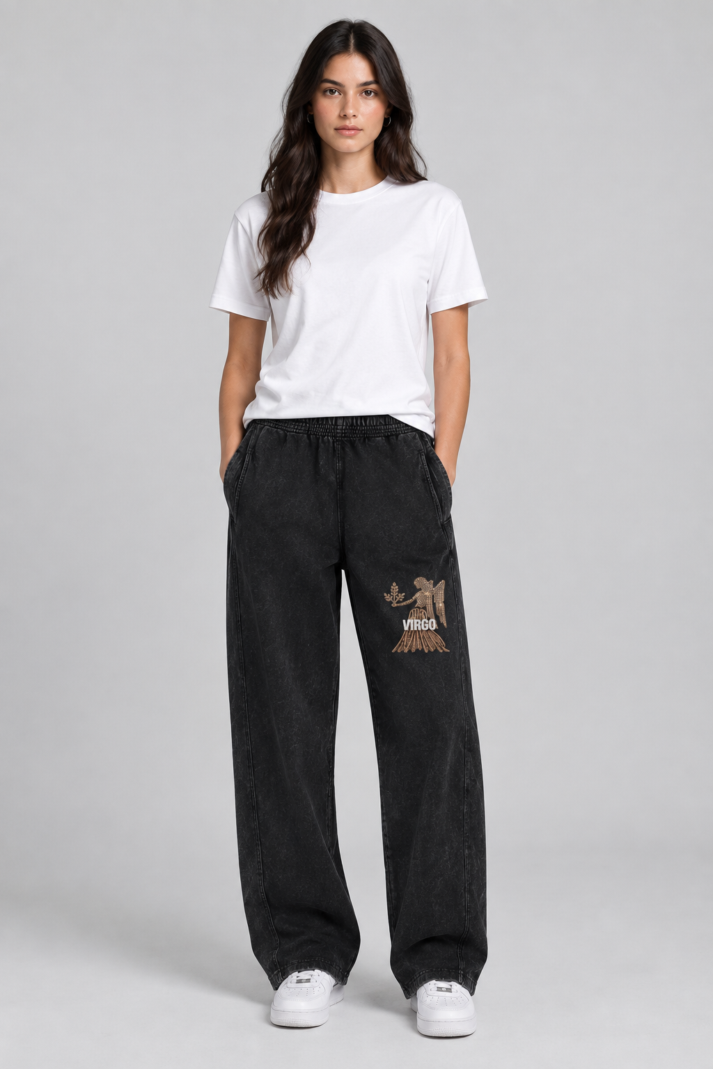 Female model wearing black Virgo mineral wash straight sweatpants, front Virgo thigh art; illustrative print
