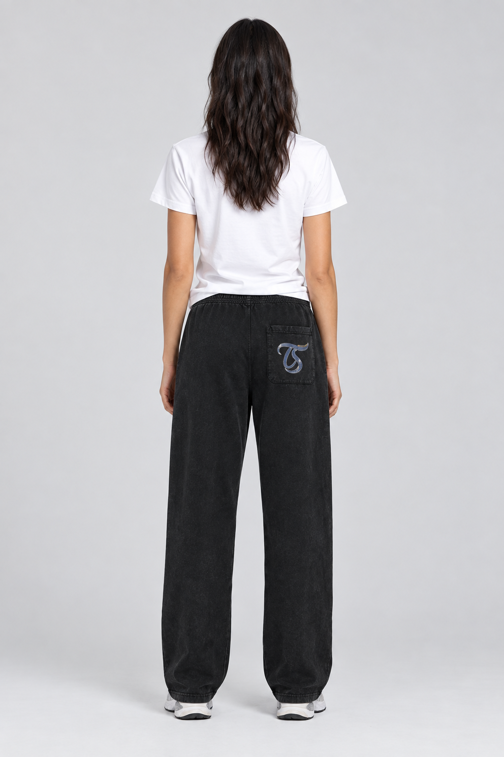 Female model wearing black Pisces mineral wash straight sweatpants, back TS pocket mark; illustrative print