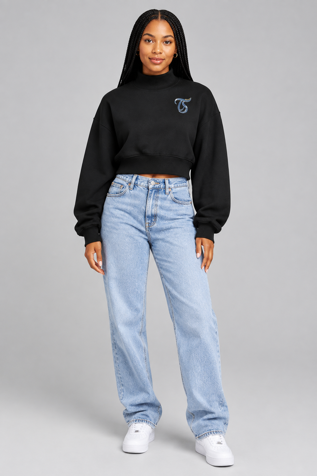 Female model in black Libra women's crop mock neck sweatshirt, front with TS chest mark; illustrative print