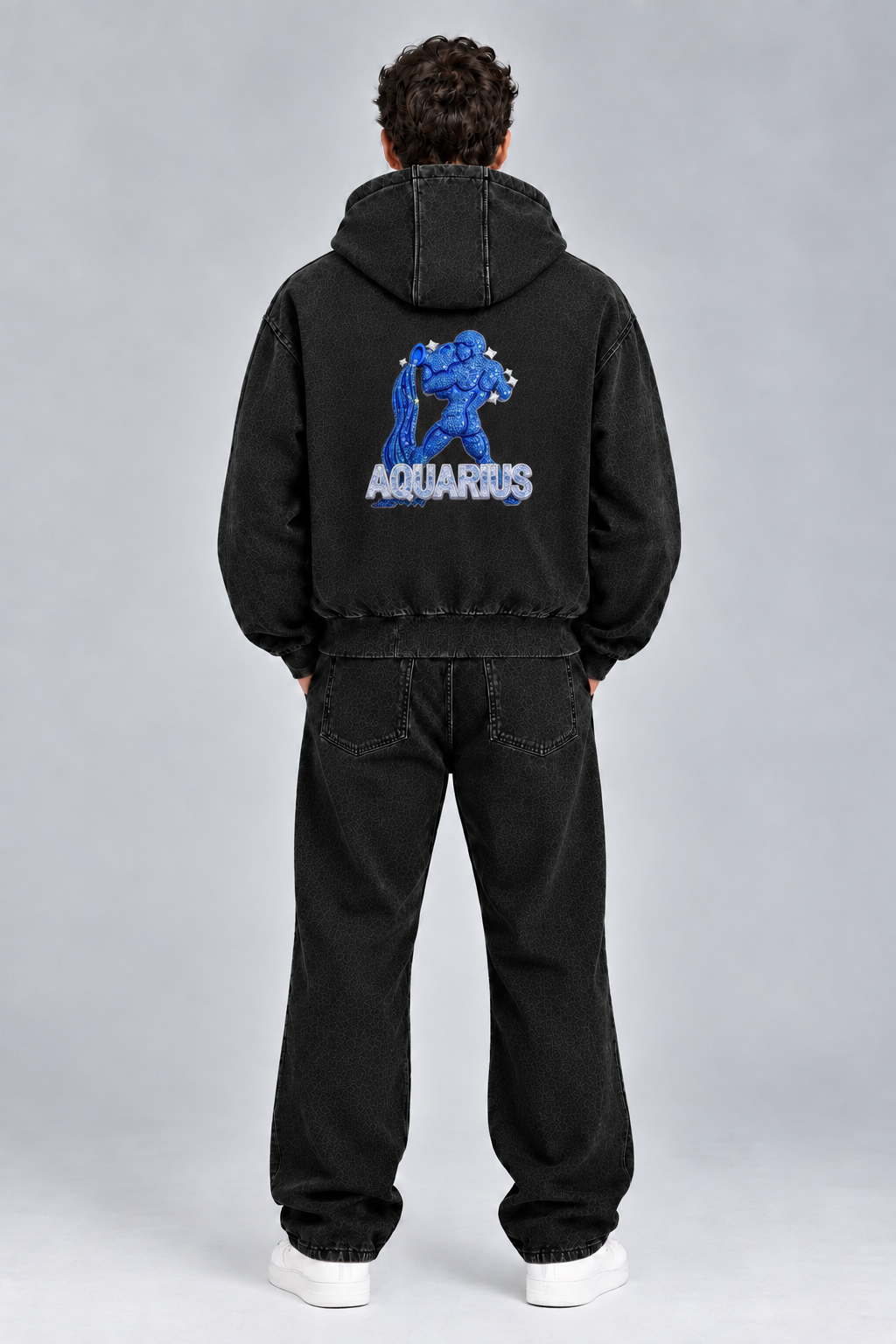 Male model wearing black Aquarius vintage wash full zip hoodie, back view; print is illustrative