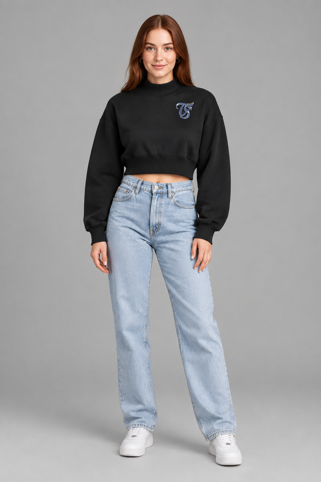Female model in black Sagittarius women's crop mock neck sweatshirt, front TS chest mark; illustrative print