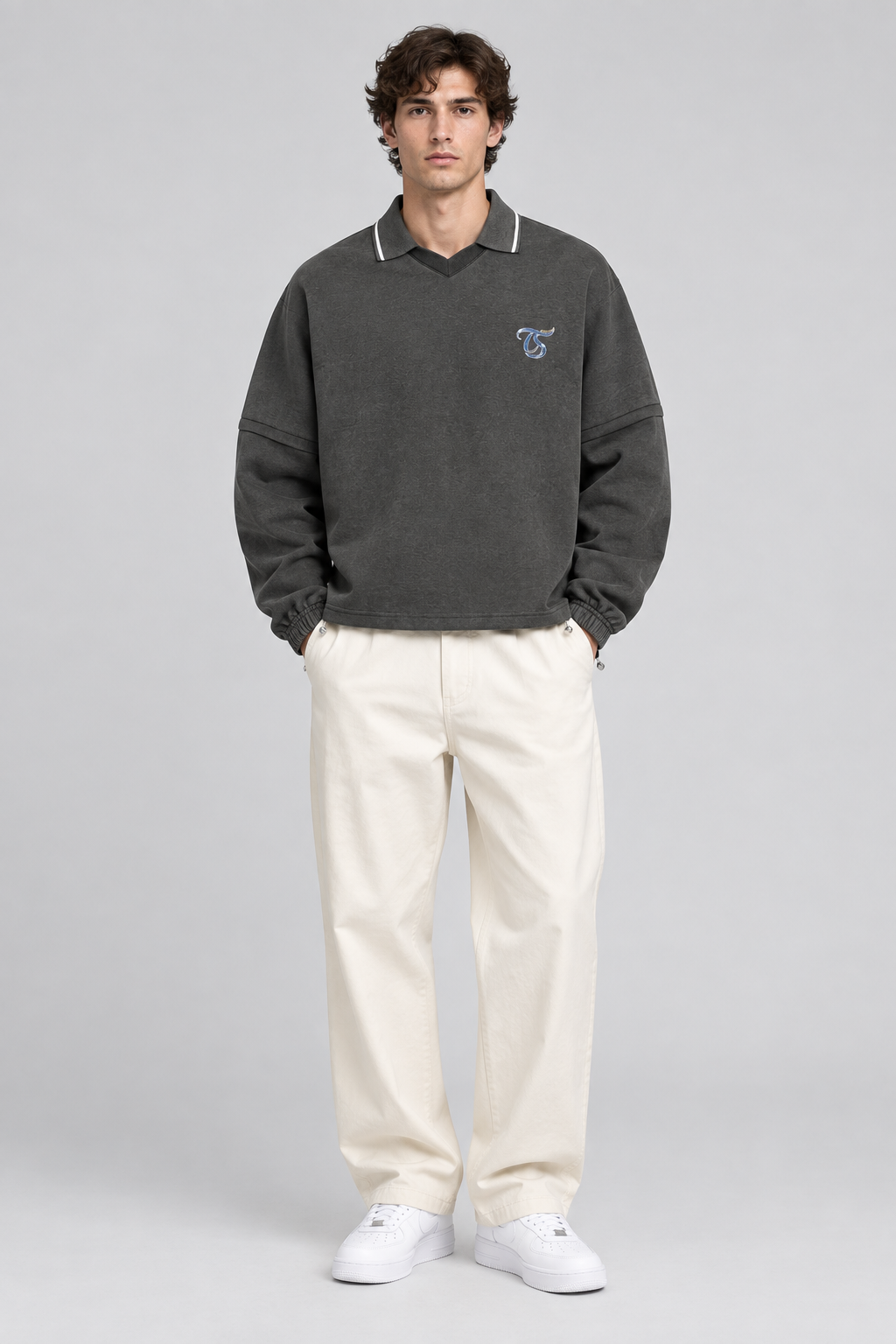 Male model wearing Pisces unisex boxy collared detachable sweatshirt, front view; illustrative styling image