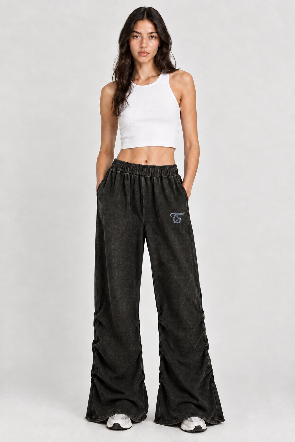 Female model wearing black Aries vintage wash ruched sweatpants with TS logo, front view