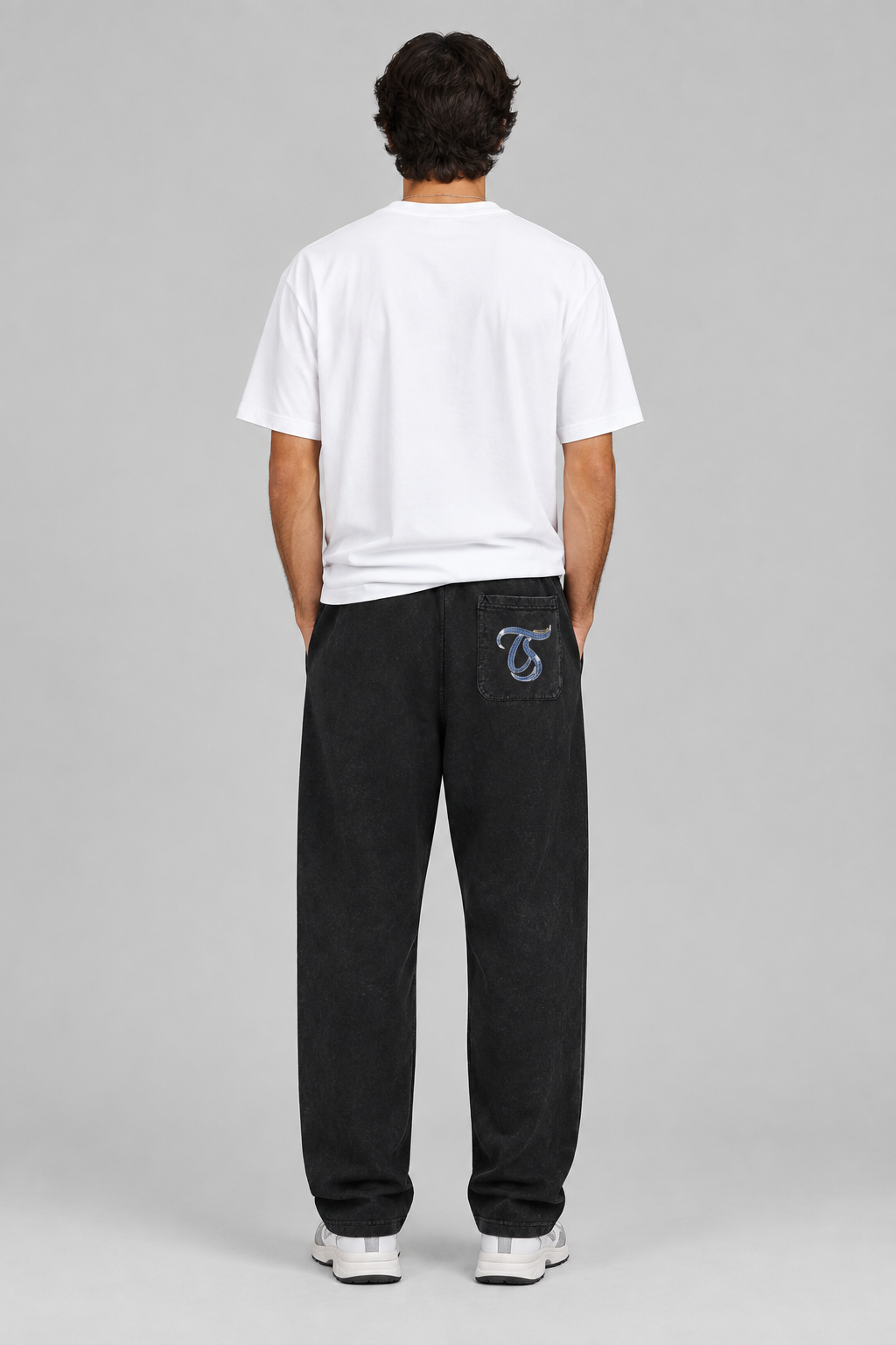 Male model wearing black Sagittarius mineral wash straight sweatpants, back TS pocket mark; illustrative print