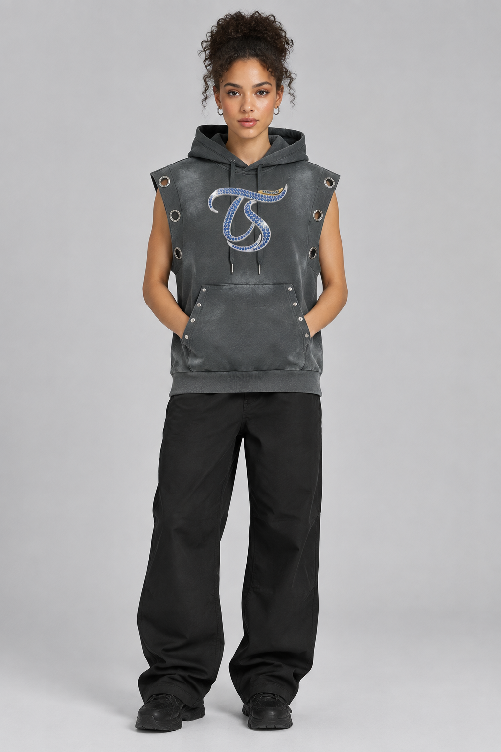 Female model wearing gray Leo sun fade sleeveless hoodie, front chest mark; illustrative styling photo