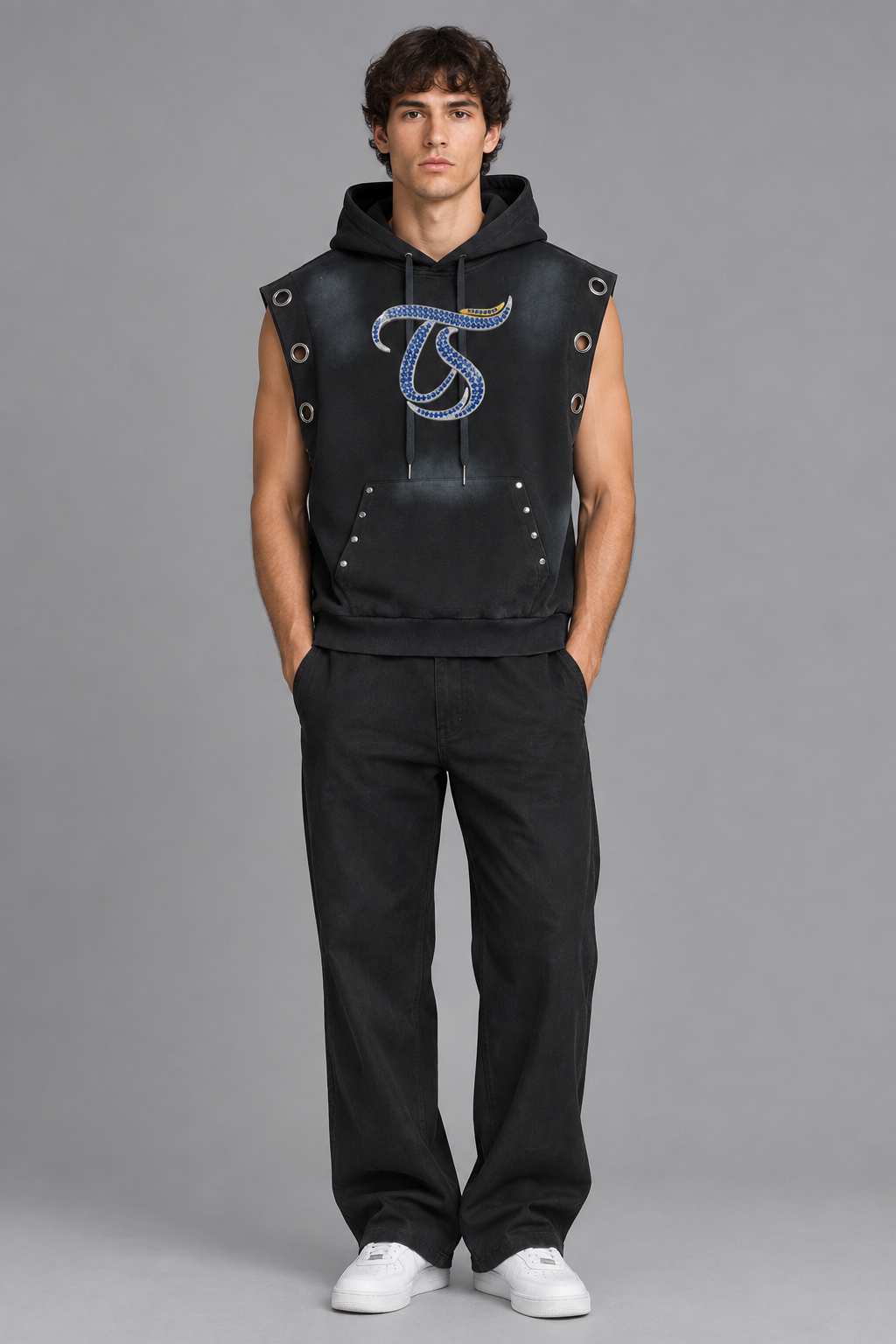 Model wearing Aries vintage wash sun fade sleeveless hoodie, front view with chest mark; illustrative styling photo