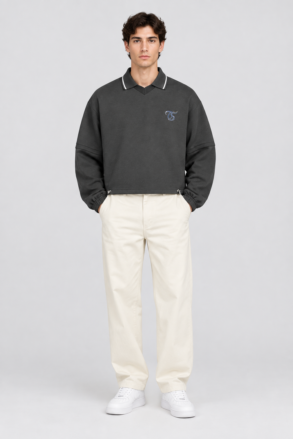 Male model wearing Leo unisex boxy collared detachable sweatshirt, front view; illustrative styling image