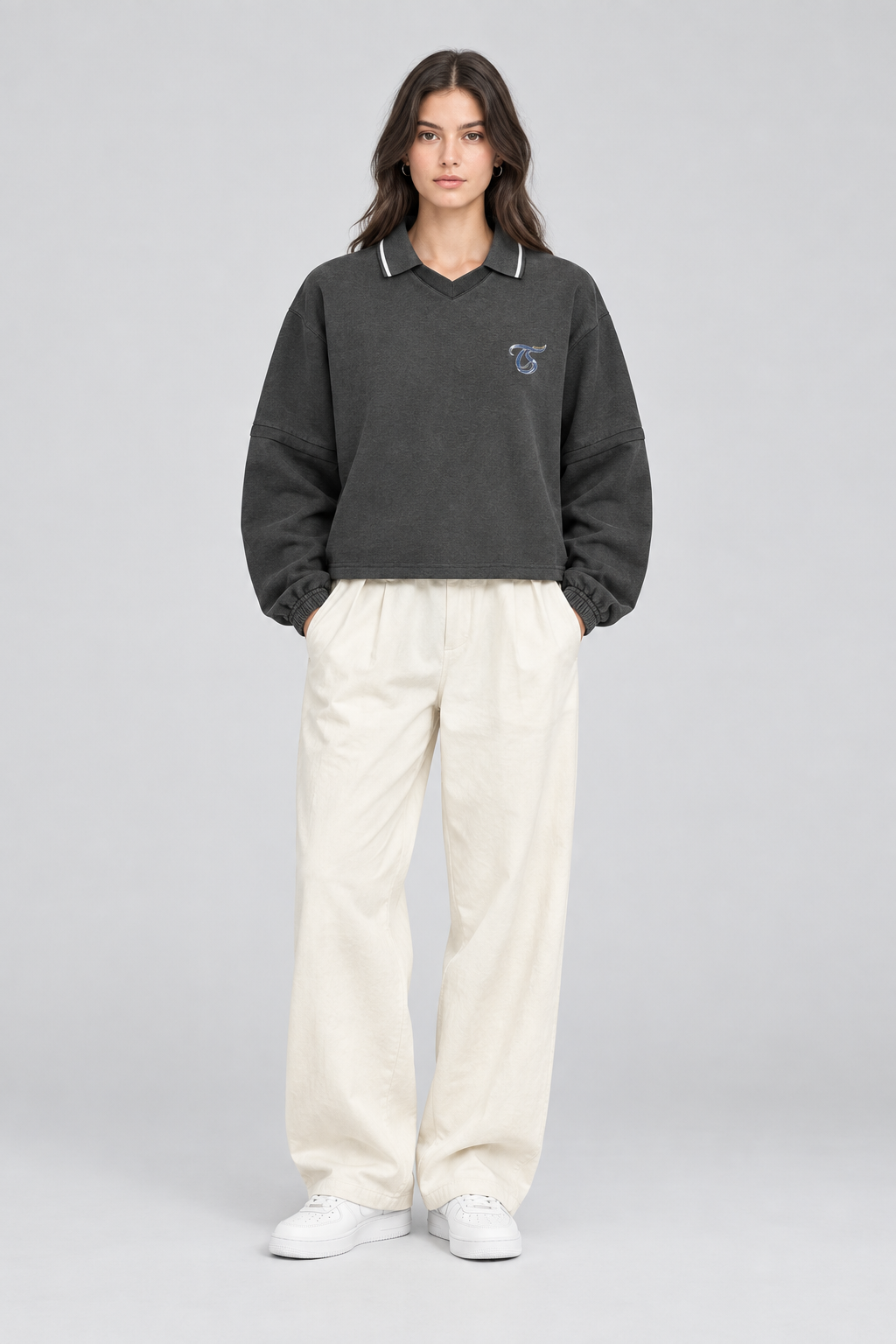 Female model wearing Sagittarius unisex boxy collared detachable sweatshirt, front view; illustrative styling image