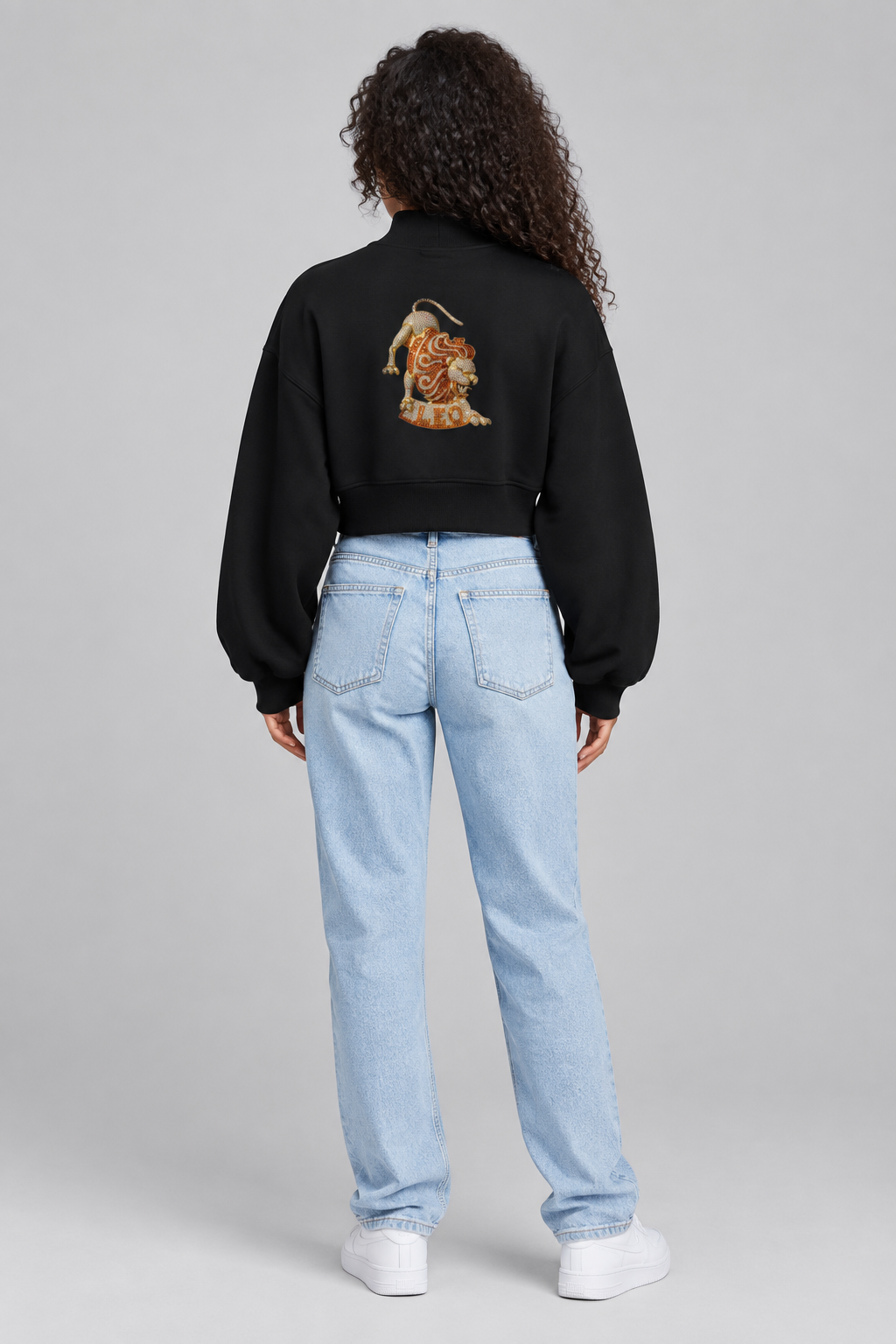 Female model in black Leo women's crop mock neck sweatshirt, back lion design; illustrative print