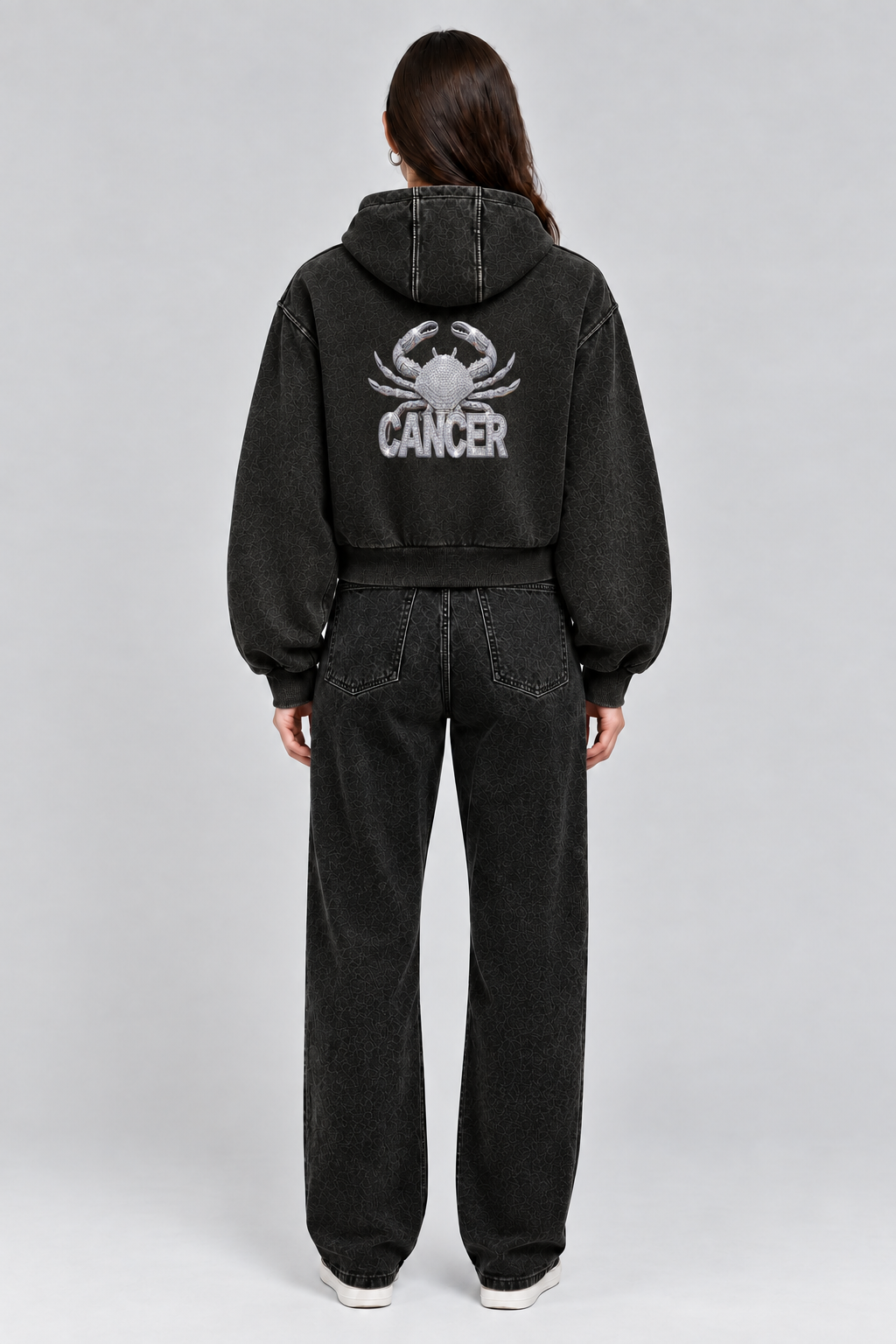 Female model wearing black Cancer vintage wash full zip hoodie, back view; print is illustrative