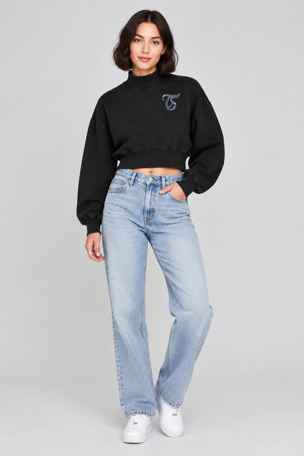 Female model in black Virgo women's crop mock neck sweatshirt, front TS chest mark; illustrative print