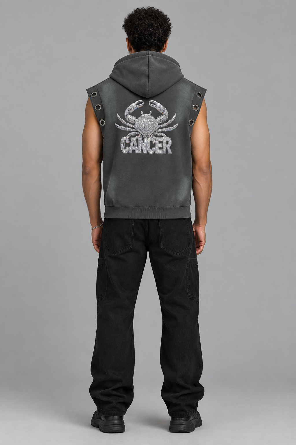 Male model wearing gray Cancer sun fade sleeveless hoodie, back crab artwork; illustrative styling photo