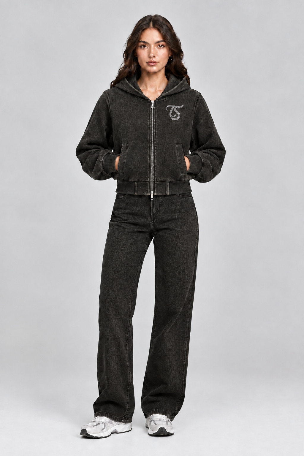 Female model wearing black Cancer vintage wash full zip hoodie with TS logo, front view; print is illustrative