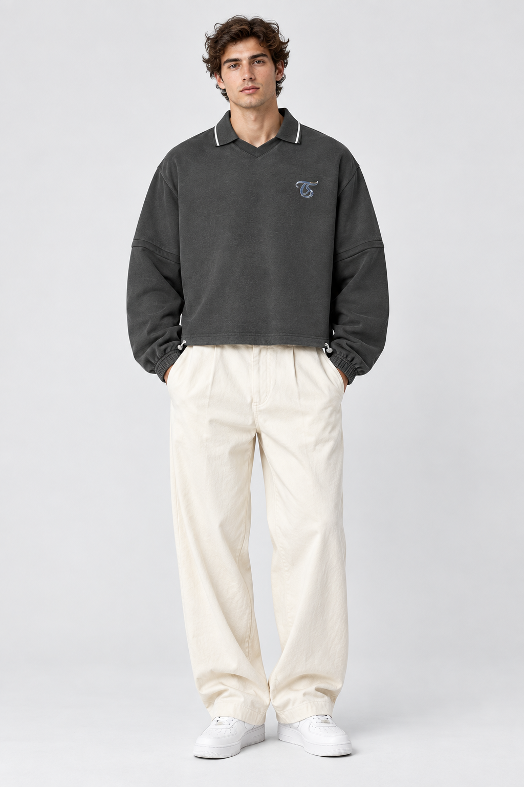 Male model wearing Capricorn unisex boxy collared detachable sweatshirt, front view; illustrative styling image