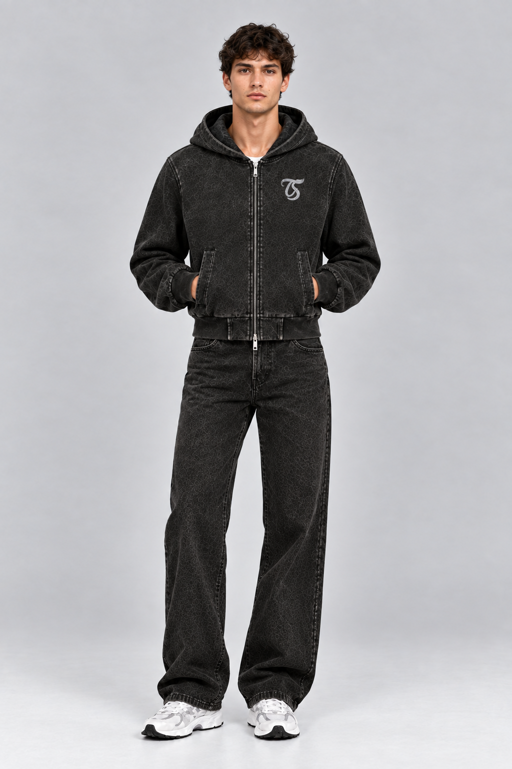 Male model wearing black Libra vintage wash full zip hoodie with TS logo, front view; print is illustrative