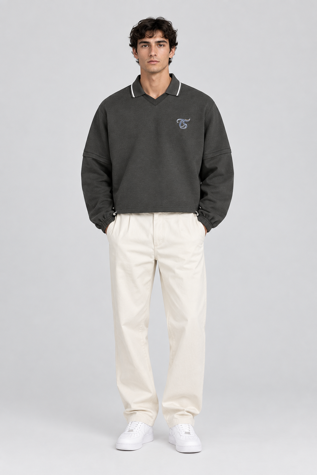 Male model wearing Gemini unisex boxy collared detachable sweatshirt, front view; illustrative styling image