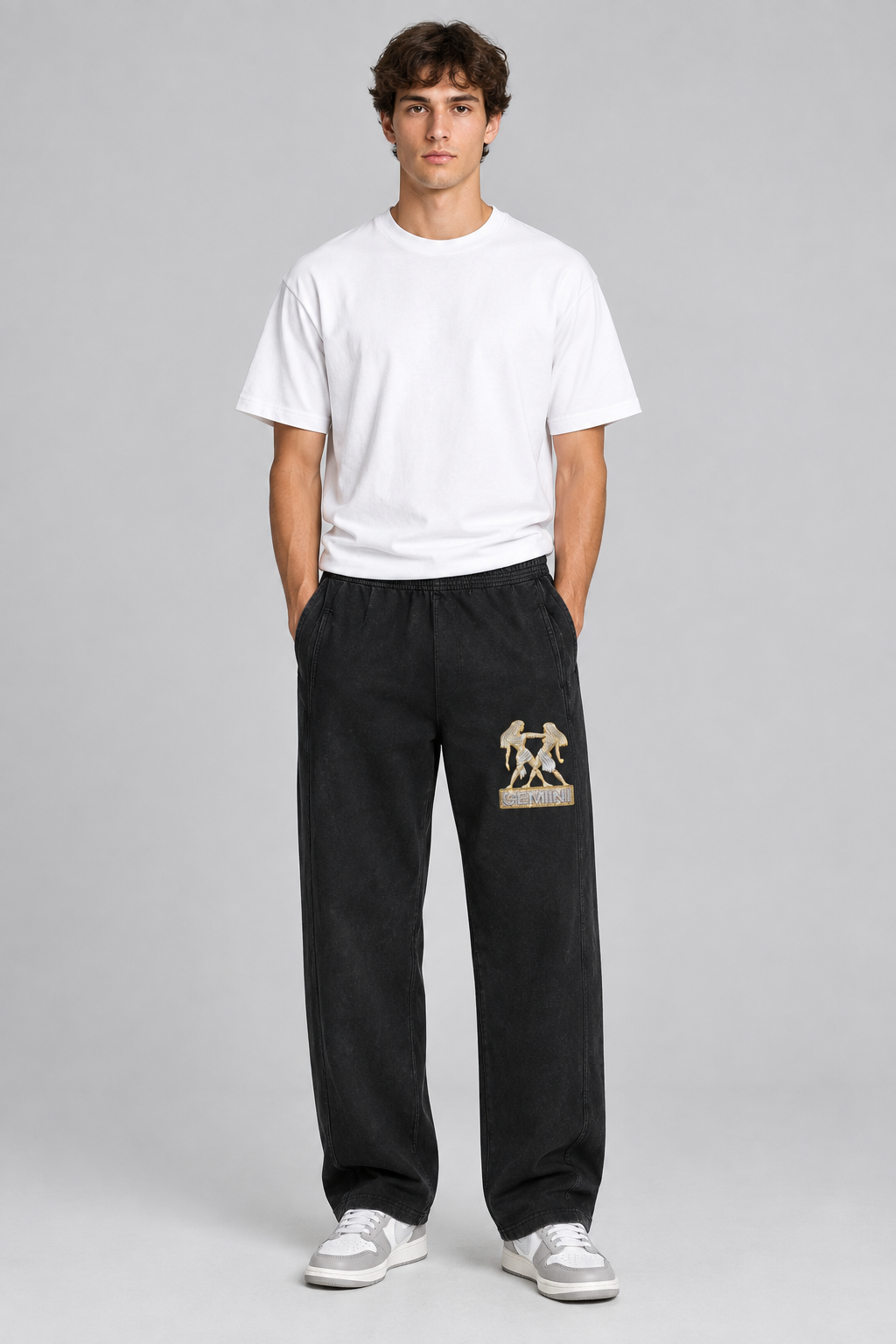 Male model wearing black Gemini mineral wash straight sweatpants, front thigh Gemini design; illustrative print