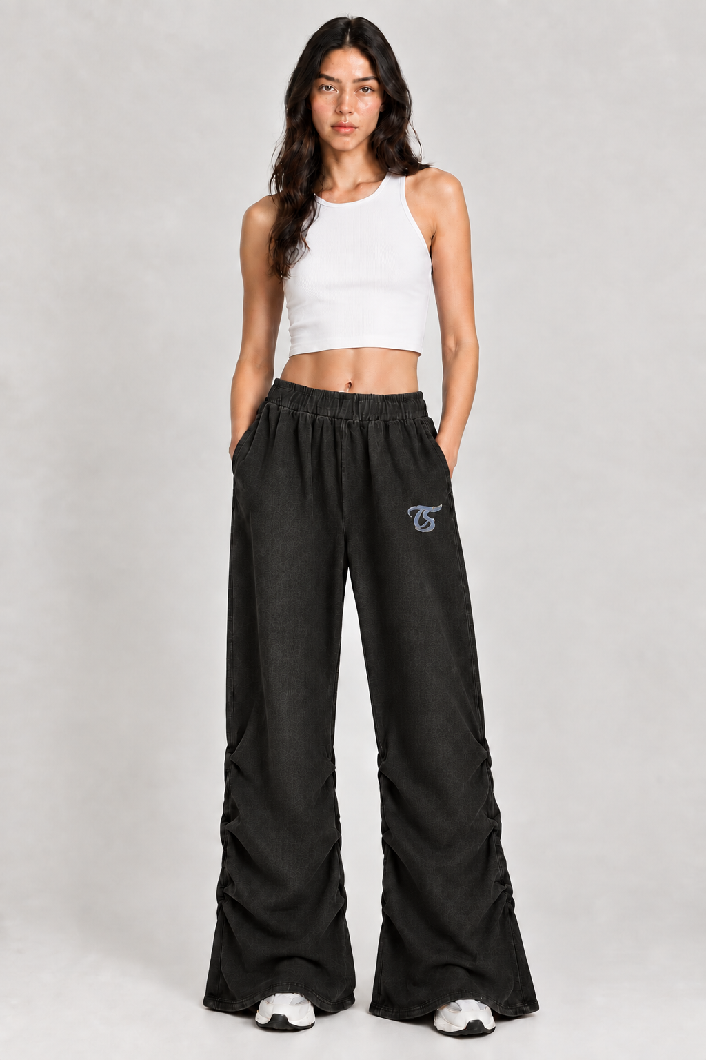 Female model wearing black Cancer vintage wash ruched sweatpants with TS logo, front view